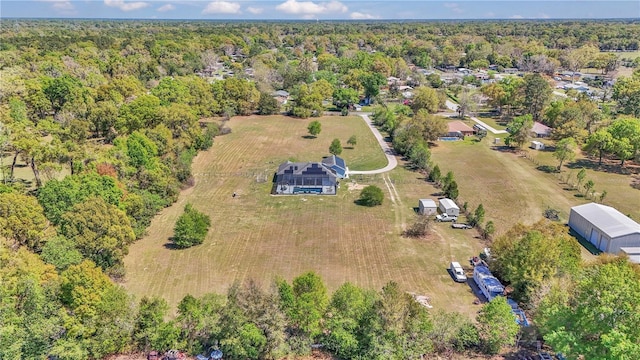 drone / aerial view featuring a forest view