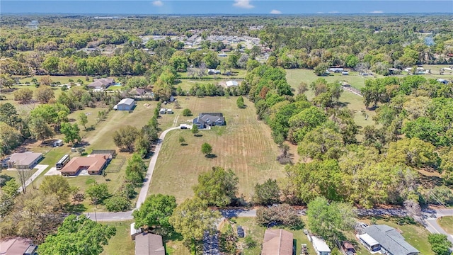 birds eye view of property featuring a forest view