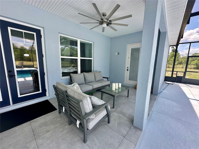 view of patio with a ceiling fan, an outdoor hangout area, and glass enclosure