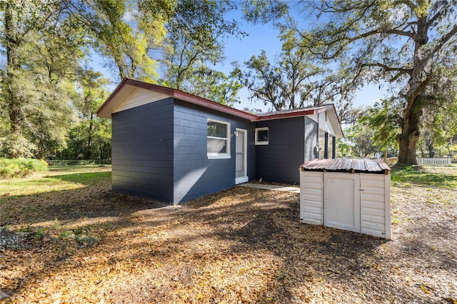 view of property exterior with an outdoor structure