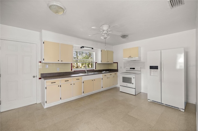 kitchen featuring visible vents, cream cabinets, dark countertops, white appliances, and ceiling fan
