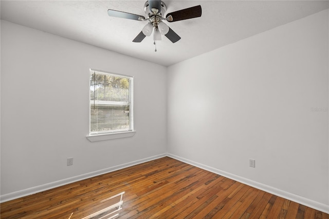 unfurnished room featuring baseboards, a ceiling fan, and hardwood / wood-style flooring