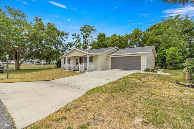 ranch-style house with an attached garage, driveway, a porch, and a front yard
