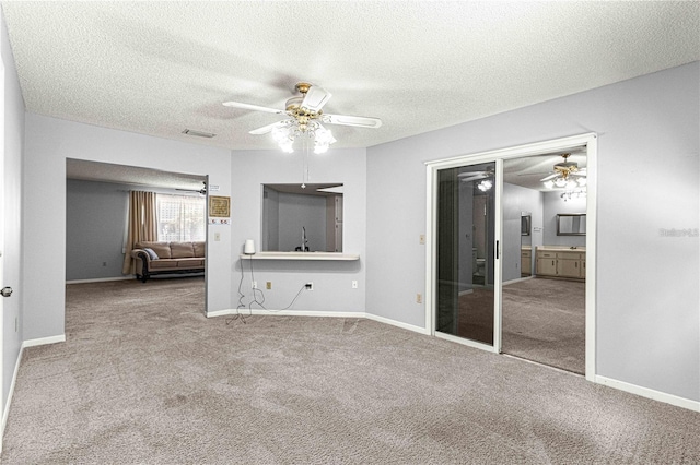 interior space with baseboards, a textured ceiling, and ceiling fan