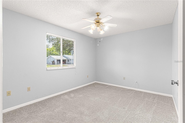 carpeted empty room featuring a textured ceiling, baseboards, and ceiling fan