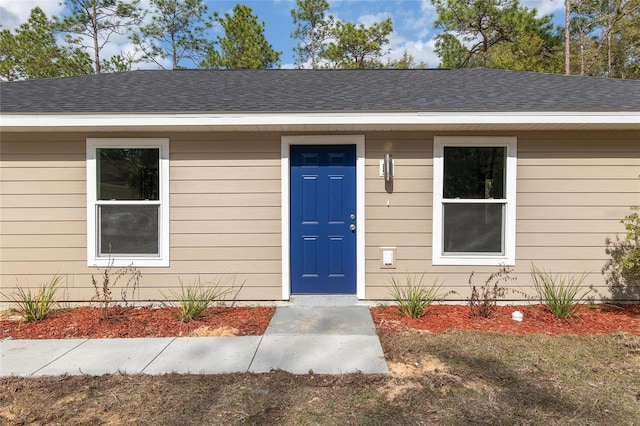 15954 SW 30th Ln, Ocala, FL 34481 - view of exterior entry with roof with shingles