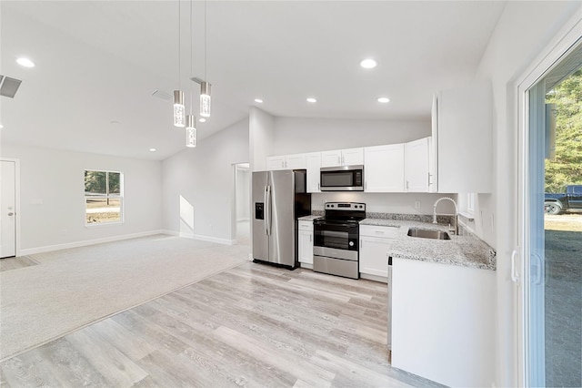15954 SW 30th Ln, Ocala, FL 34481 - kitchen featuring white cabinets, light stone countertops, appliances with stainless steel finishes, a sink, and decorative light fixtures