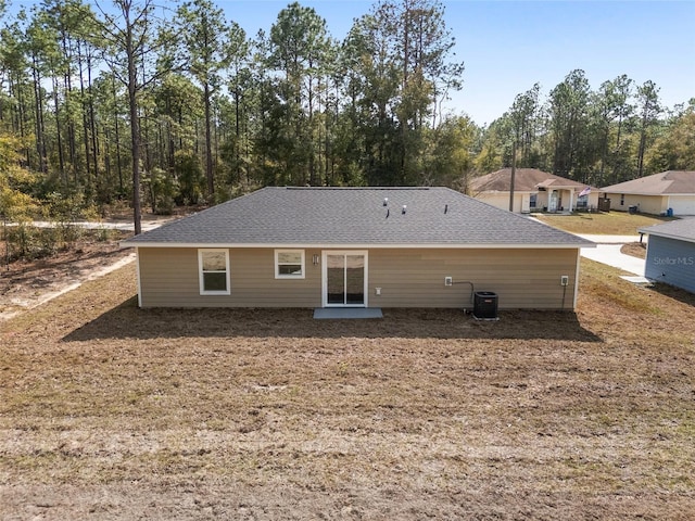 15954 SW 30th Ln, Ocala, FL 34481 - rear view of property featuring central AC and roof with shingles
