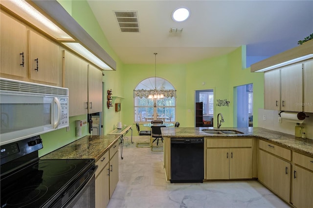 kitchen featuring visible vents, black appliances, light brown cabinets, a sink, and a peninsula