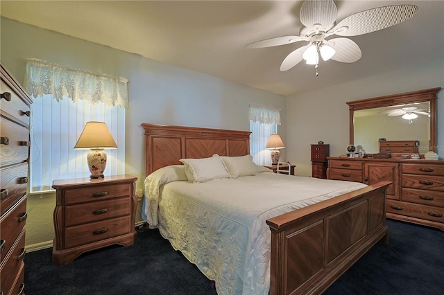 bedroom with dark colored carpet and a ceiling fan