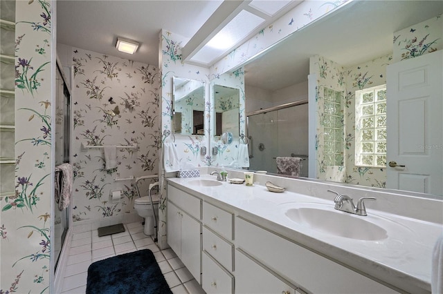 bathroom featuring a shower stall, wallpapered walls, double vanity, tile patterned floors, and a sink