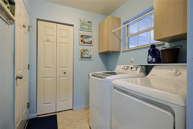 laundry room featuring baseboards, cabinet space, and independent washer and dryer