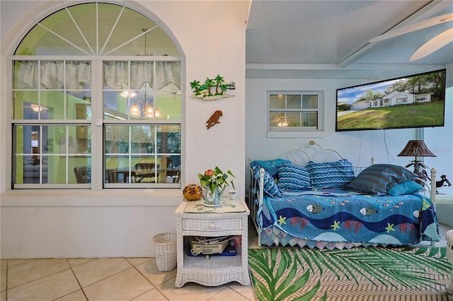 bedroom featuring tile patterned floors and a chandelier