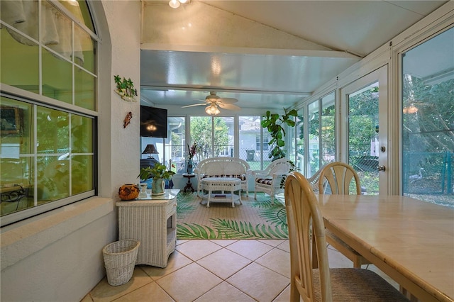 sunroom featuring tile patterned flooring and lofted ceiling