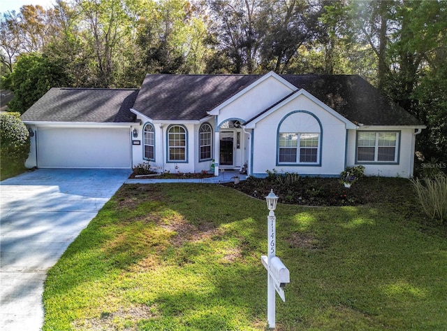 ranch-style home featuring concrete driveway, a front yard, roof with shingles, stucco siding, and an attached garage