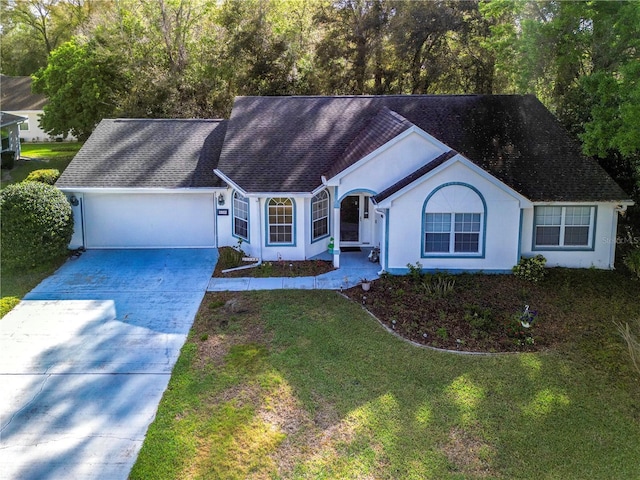ranch-style home with a garage, stucco siding, driveway, and a front lawn