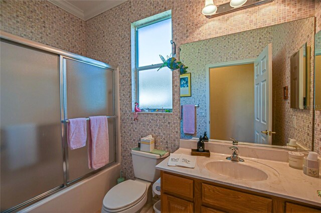 13968 SE 96th Cir, Summerfield, FL 34491 - bathroom featuring shower / bath combination with glass door, crown molding, toilet, and vanity
