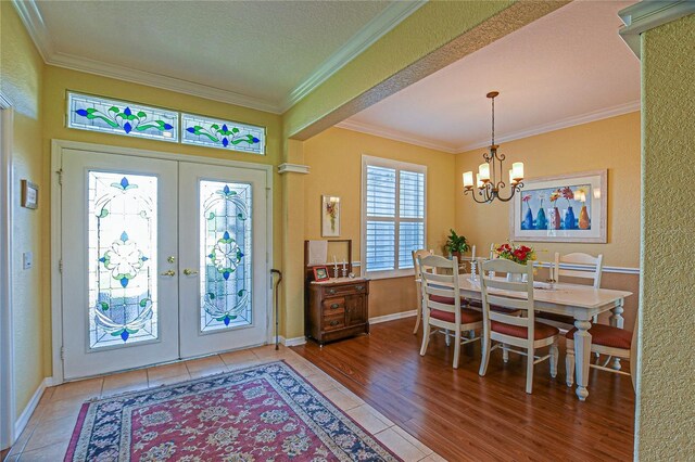 13968 SE 96th Cir, Summerfield, FL 34491 - foyer entrance featuring ornamental molding, french doors, a chandelier, and baseboards