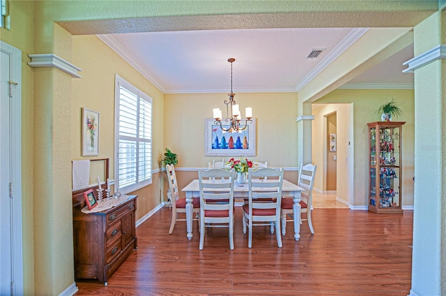 13968 SE 96th Cir, Summerfield, FL 34491 - dining space featuring wood finished floors, crown molding, a chandelier, and baseboards