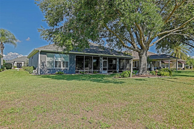 13968 SE 96th Cir, Summerfield, FL 34491 - rear view of property featuring a lawn and a sunroom