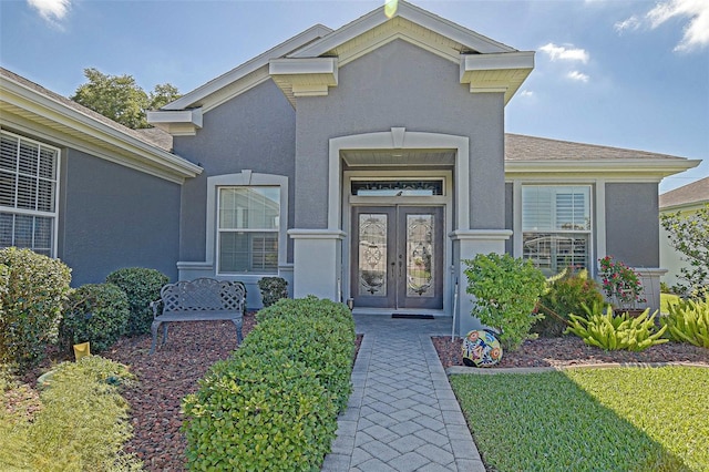 13968 SE 96th Cir, Summerfield, FL 34491 - doorway to property featuring stucco siding and french doors