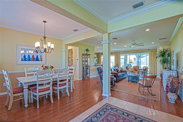 13968 SE 96th Cir, Summerfield, FL 34491 - dining room with decorative columns, wood finished floors, crown molding, recessed lighting, and baseboards