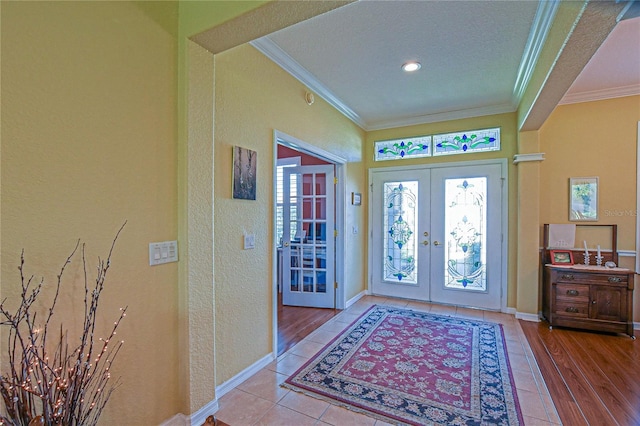 13968 SE 96th Cir, Summerfield, FL 34491 - entryway with french doors, crown molding, a textured wall, tile patterned flooring, and baseboards