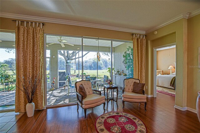 13968 SE 96th Cir, Summerfield, FL 34491 - sitting room featuring wood-type flooring, ornamental molding, plenty of natural light, and a ceiling fan