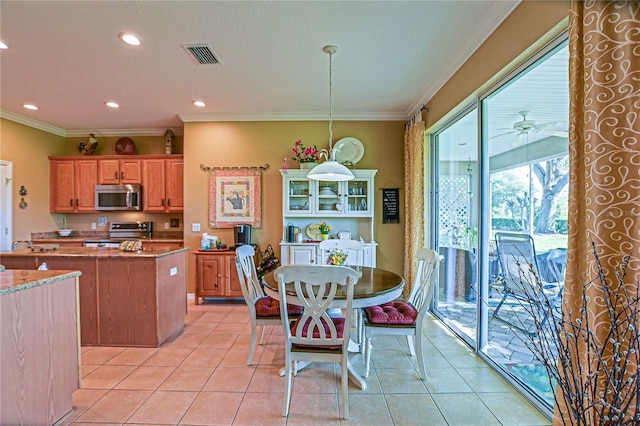 13968 SE 96th Cir, Summerfield, FL 34491 - kitchen featuring appliances with stainless steel finishes, light tile patterned floors, ornamental molding, decorative light fixtures, and recessed lighting