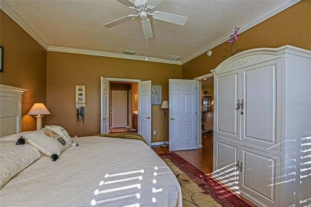 13968 SE 96th Cir, Summerfield, FL 34491 - bedroom featuring wood finished floors, a textured ceiling, crown molding, and ceiling fan