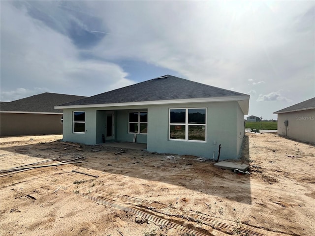 4504 SW 90th Lane Rd, Ocala, FL 34476 - back of house with a shingled roof and stucco siding