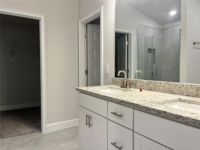 4504 SW 90th Lane Rd, Ocala, FL 34476 - bathroom featuring a shower stall, double vanity, a spacious closet, and lofted ceiling