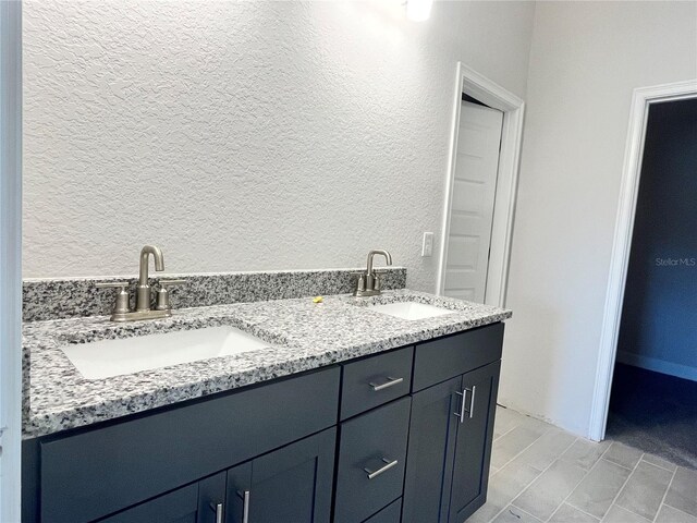 4504 SW 90th Lane Rd, Ocala, FL 34476 - bathroom featuring a textured wall and double vanity