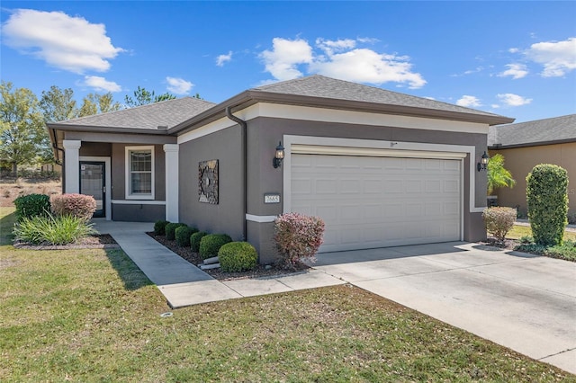 ranch-style home featuring stucco siding, roof with shingles, driveway, a front yard, and a garage