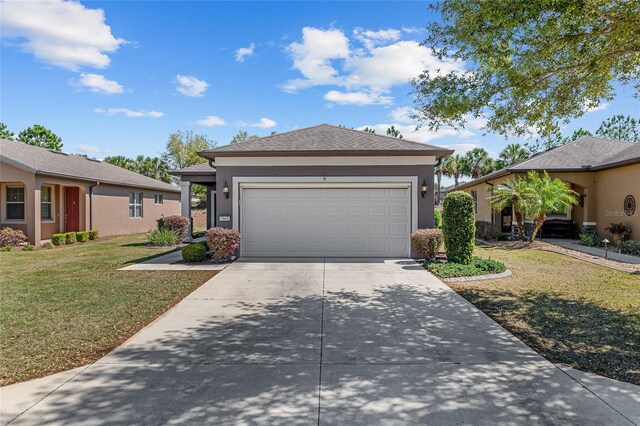 view of front of home with a front yard, stucco siding, an attached garage, and concrete driveway