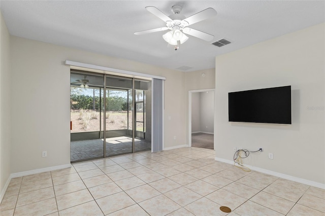 unfurnished room with light tile patterned flooring, baseboards, visible vents, and a ceiling fan