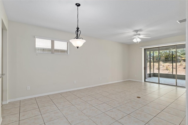 spare room with baseboards, visible vents, a ceiling fan, and plenty of natural light