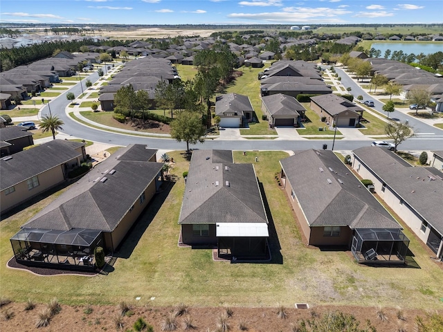 drone / aerial view with a water view and a residential view