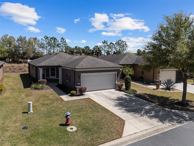 single story home featuring an attached garage, concrete driveway, a front yard, stucco siding, and a shingled roof
