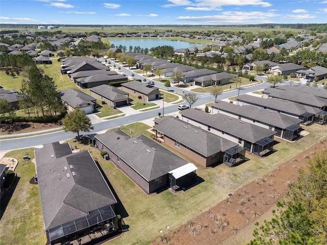 drone / aerial view with a water view and a residential view