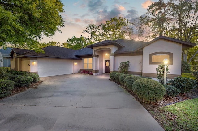 8869 SW 194th Ct, Dunnellon, FL 34432 - view of front of house with an attached garage, stucco siding, and concrete driveway