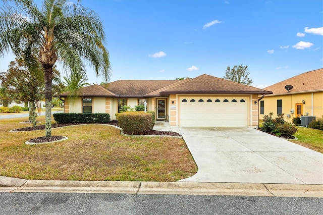 ranch-style house featuring central AC unit, stucco siding, concrete driveway, a front lawn, and a garage