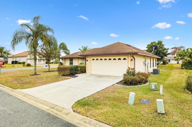 single story home featuring stucco siding, driveway, a front lawn, cooling unit, and an attached garage