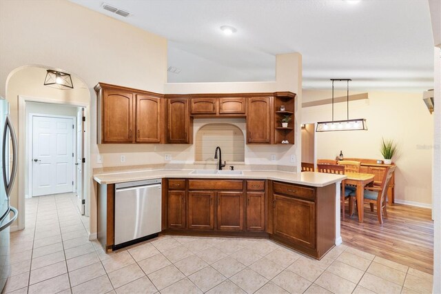 kitchen with visible vents, light countertops, lofted ceiling, appliances with stainless steel finishes, and a sink