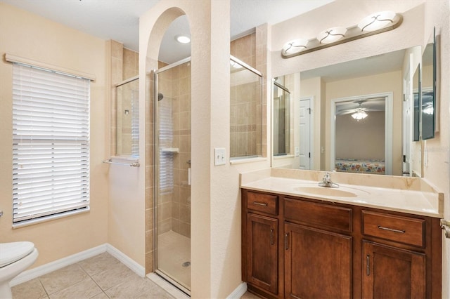 ensuite bathroom featuring tile patterned flooring, connected bathroom, a shower stall, and a ceiling fan