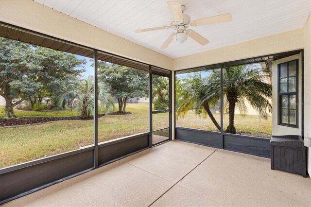 unfurnished sunroom with a ceiling fan