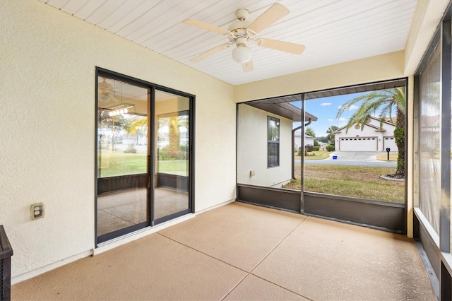 unfurnished sunroom with a ceiling fan