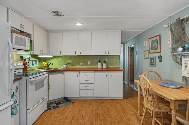 5368 S Parkland Ter, Homosassa, FL 34448 - kitchen with white cabinets, white appliances, and light wood-style floors