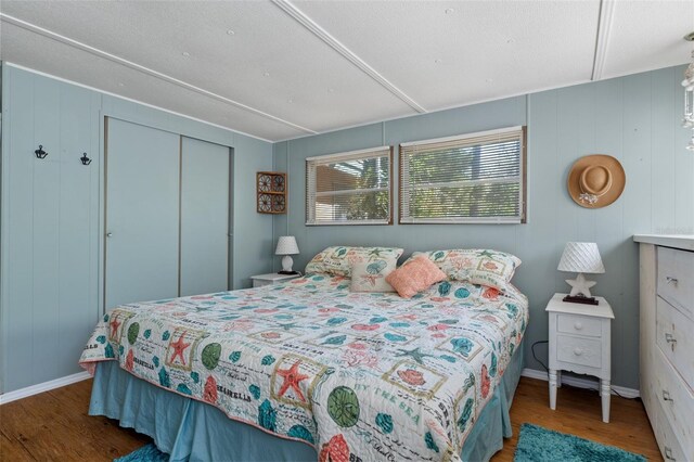 5368 S Parkland Ter, Homosassa, FL 34448 - bedroom featuring a closet, a decorative wall, baseboards, and wood finished floors