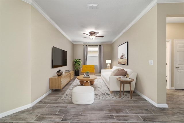 living area featuring ornamental molding, a ceiling fan, visible vents, and baseboards